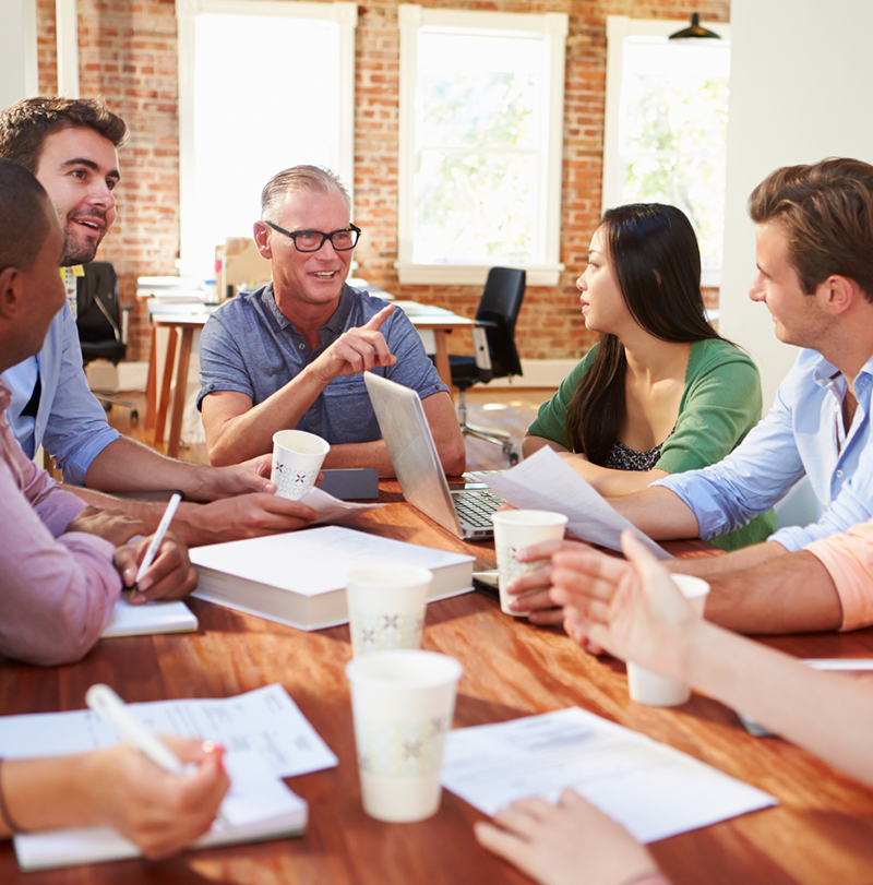 Group of people sitting at table talking